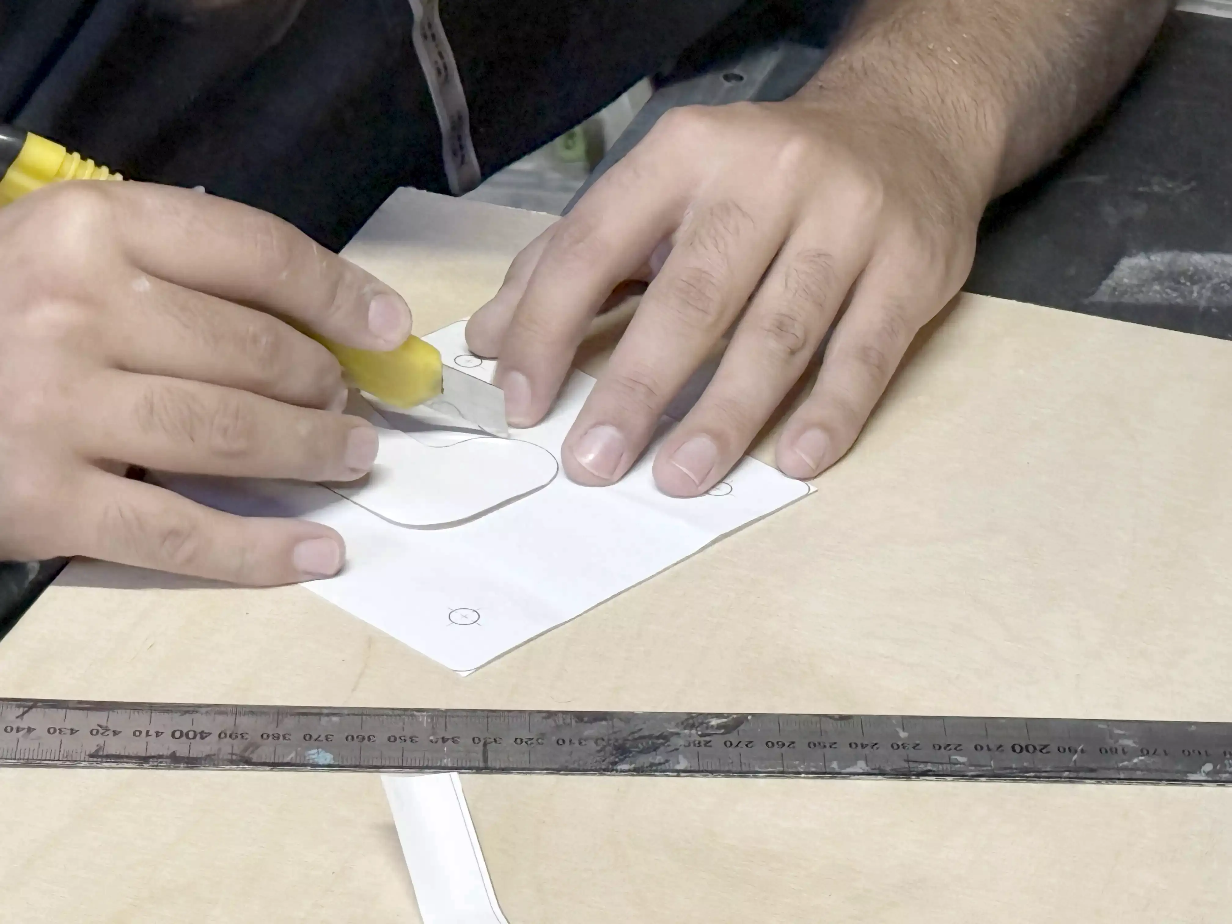 Cutting out the paper template.